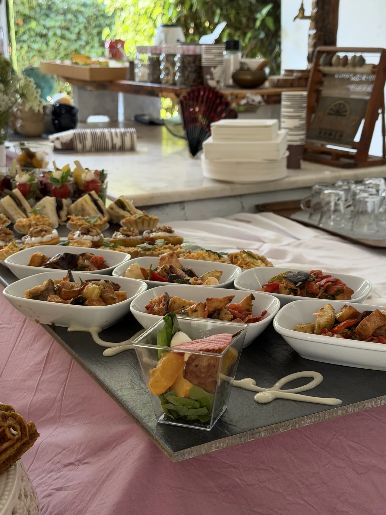 A buffet with individually arranged bites and small bowls.