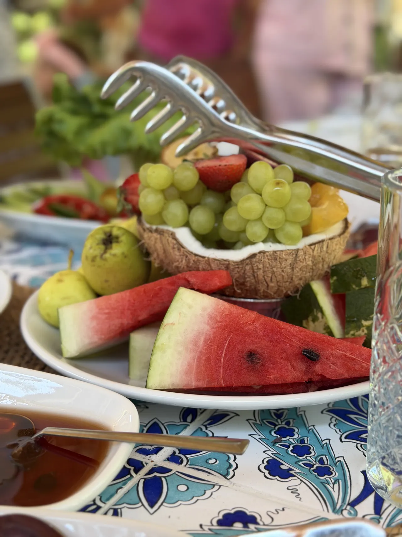 A fruit platter with watermelon, grapes and pears.